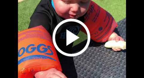 hilarius Video Of baby Attempting To Eat Banana While Wearing Floaties